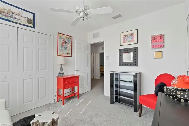 a living room with furniture and a lamp