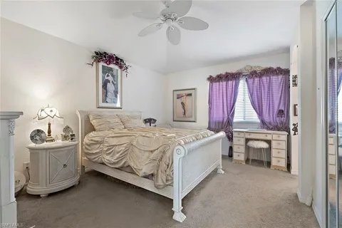 a bed room with a bed and a chair