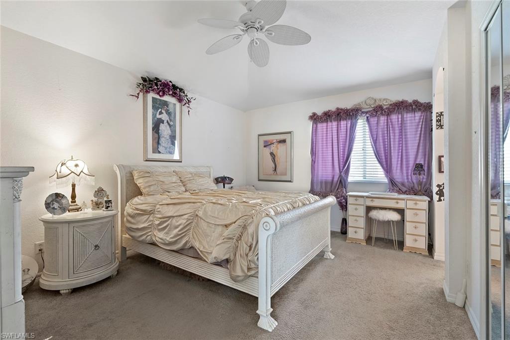 9838 Roundstone Circle Fort Myers, FL 33967 - Photo 17 of 25 a bed room with a bed and a chair