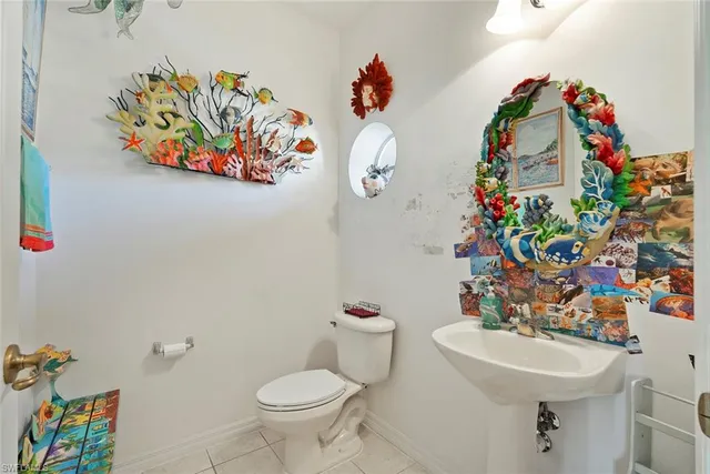 a bathroom with a sink mirror and toilet