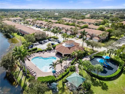 an aerial view of residential houses with outdoor space and parking