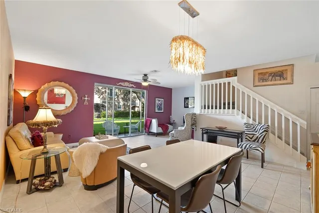 a view of a dining room with furniture a chandelier and wooden floor