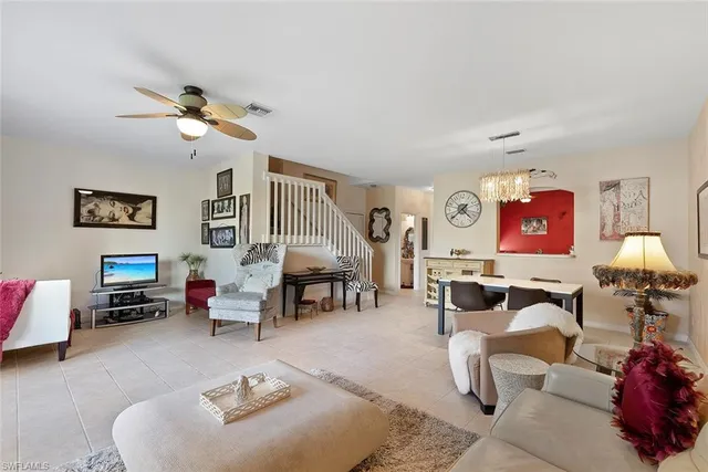 a living room with furniture a rug and white walls