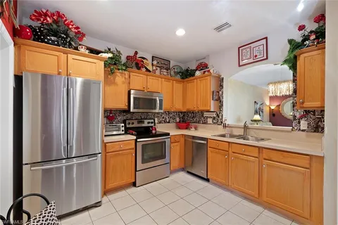 a kitchen with stainless steel appliances a refrigerator sink and cabinets