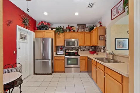 a kitchen with granite countertop a refrigerator and a sink