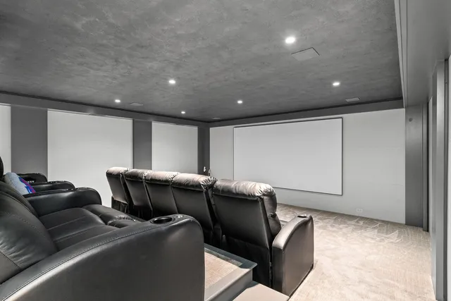 a kitchen with stainless steel appliances a dining table chairs refrigerator and sink