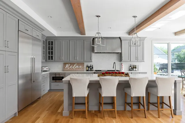a living room with furniture a fireplace and a chandelier
