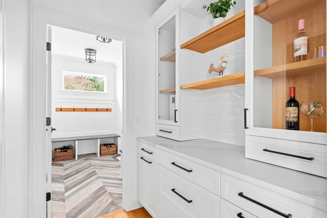 a bathroom with a white tub sink and window