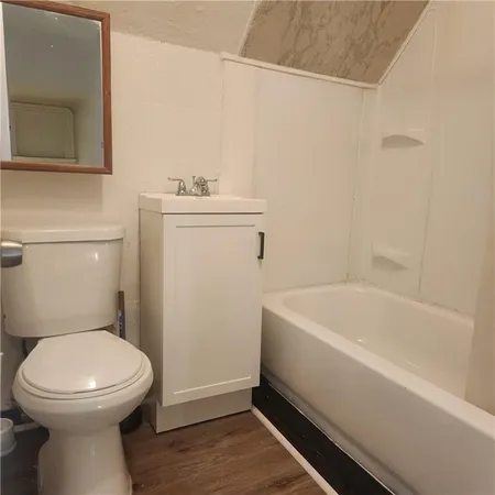 a bathroom with a sink a toilet and bathtub
