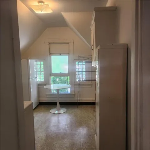 a view of room with window and wooden floor