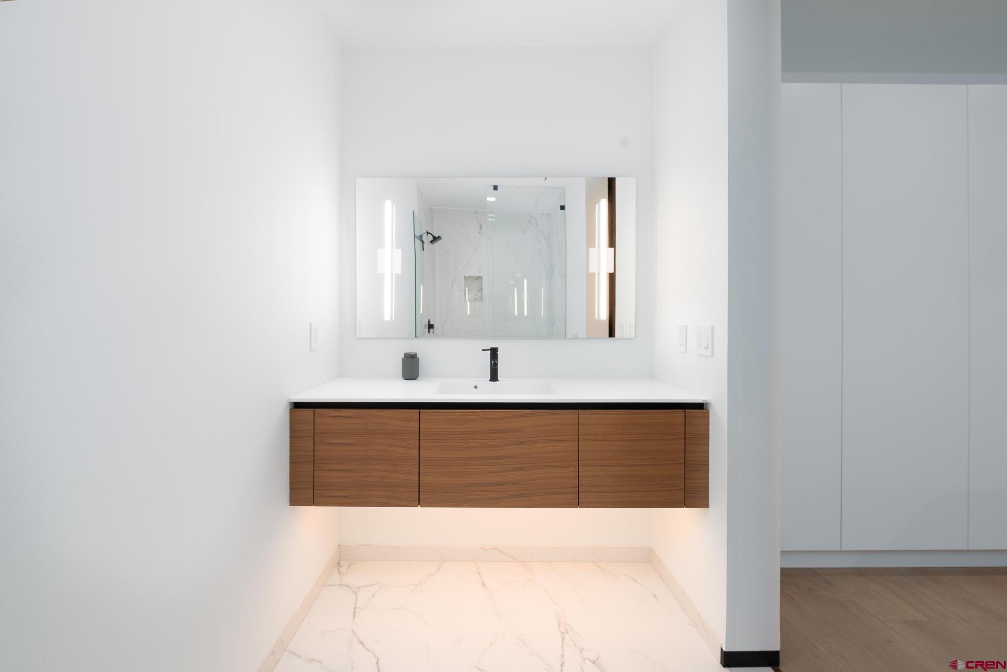 1201 Main Avenue, Unit 105 Durango, CO 81301 - Photo 29 of 45 a en suite bathroom with a sink and a mirror