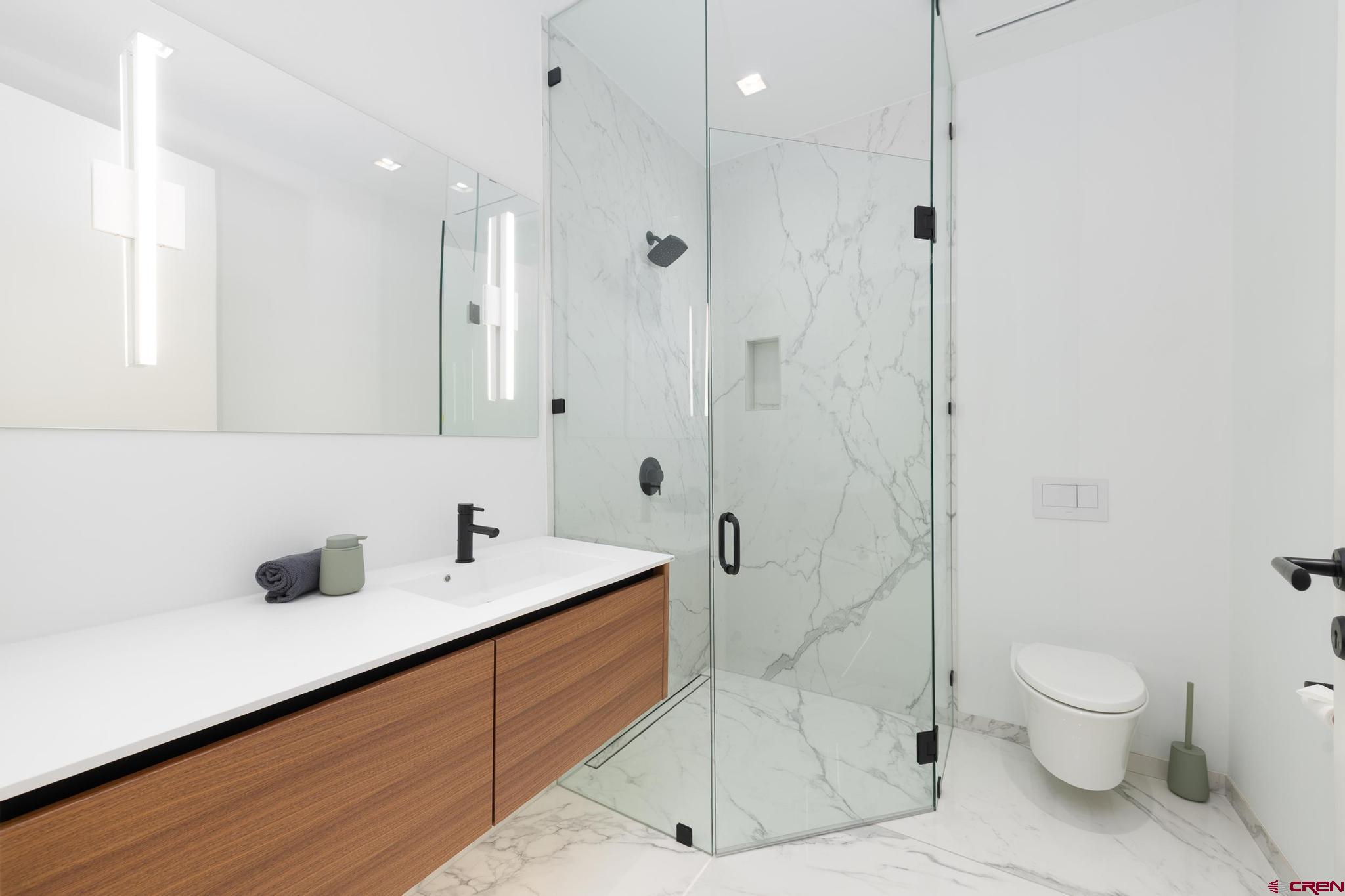 1201 Main Avenue, Unit 105 Durango, CO 81301 - Photo 5 of 45 a bathroom with a sink a toilet and shower
