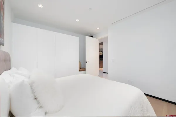 a large white bed in a white room
