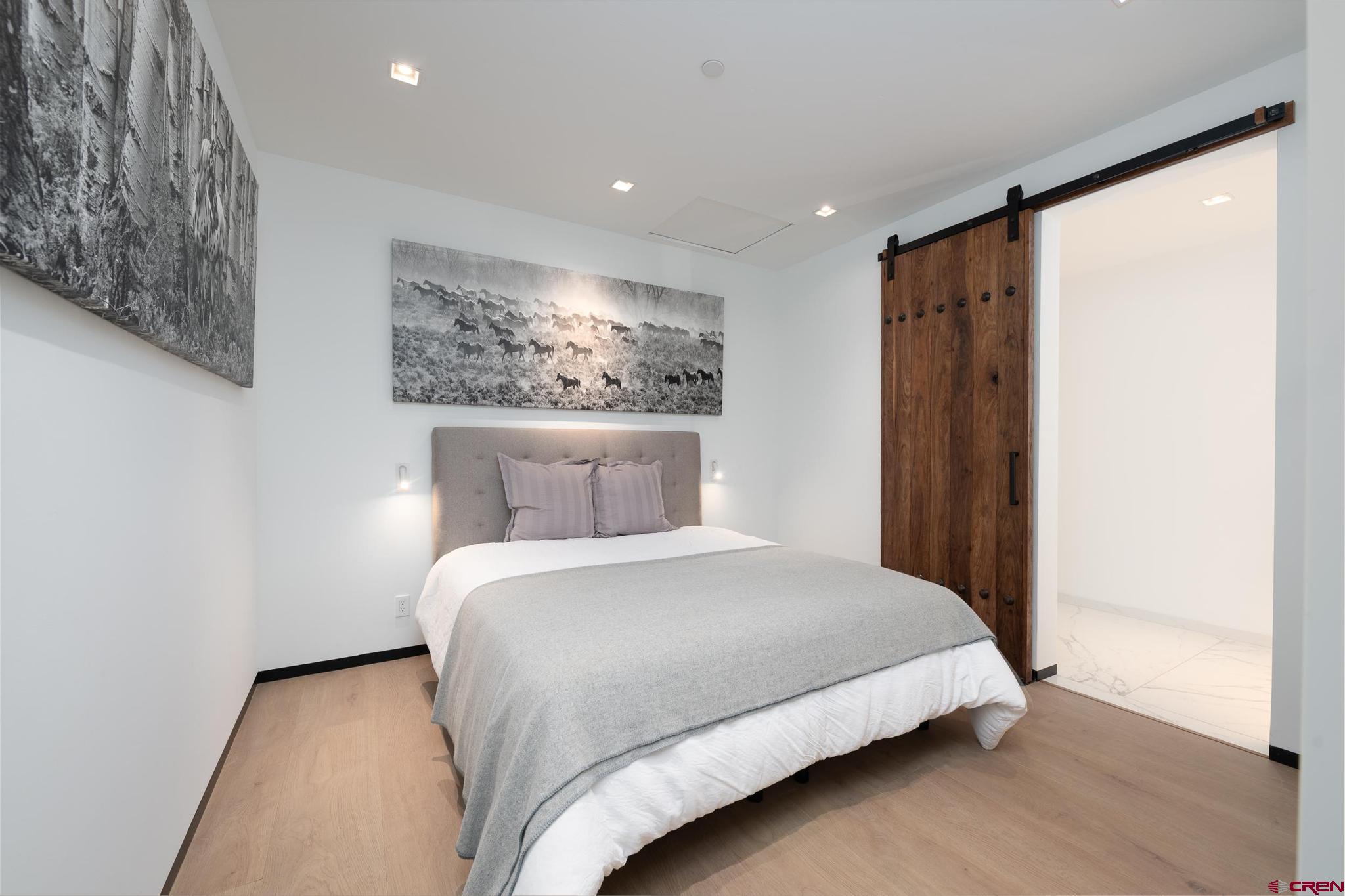 1201 Main Avenue, Unit 105 Durango, CO 81301 - Photo 10 of 45 a bedroom with a large bed and a large window