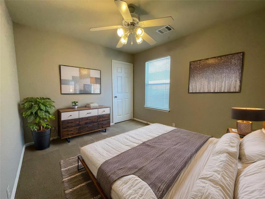 208 Spruce Drive Kyle, TX 78640 - Photo 15 of 26 a bedroom with a bed and ceiling fan