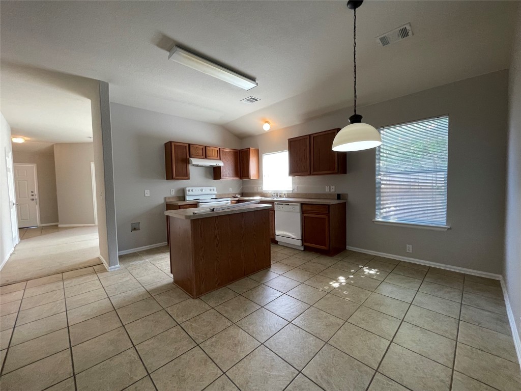 208 Spruce Drive Kyle, TX 78640 - Photo 5 of 26 a kitchen with stainless steel appliances granite countertop a stove a sink a refrigerator and a cabinets