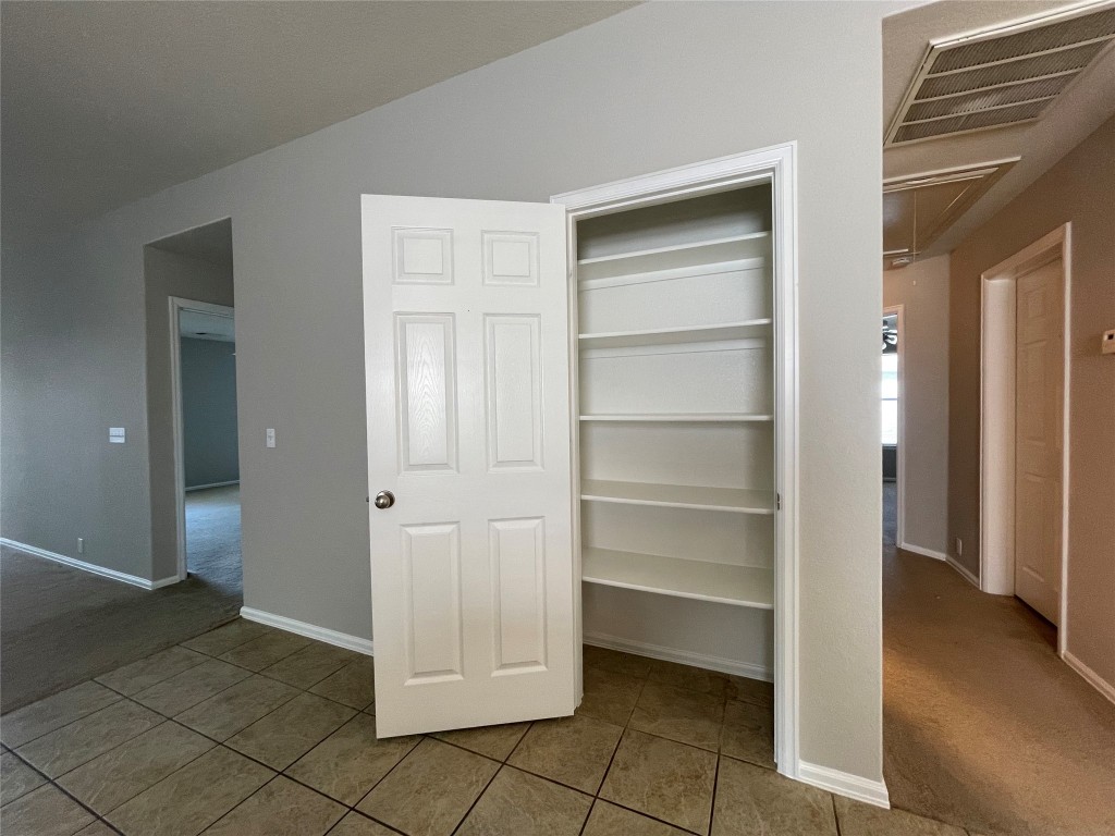 208 Spruce Drive Kyle, TX 78640 - Photo 9 of 26 a view of walk in closet with empty racks