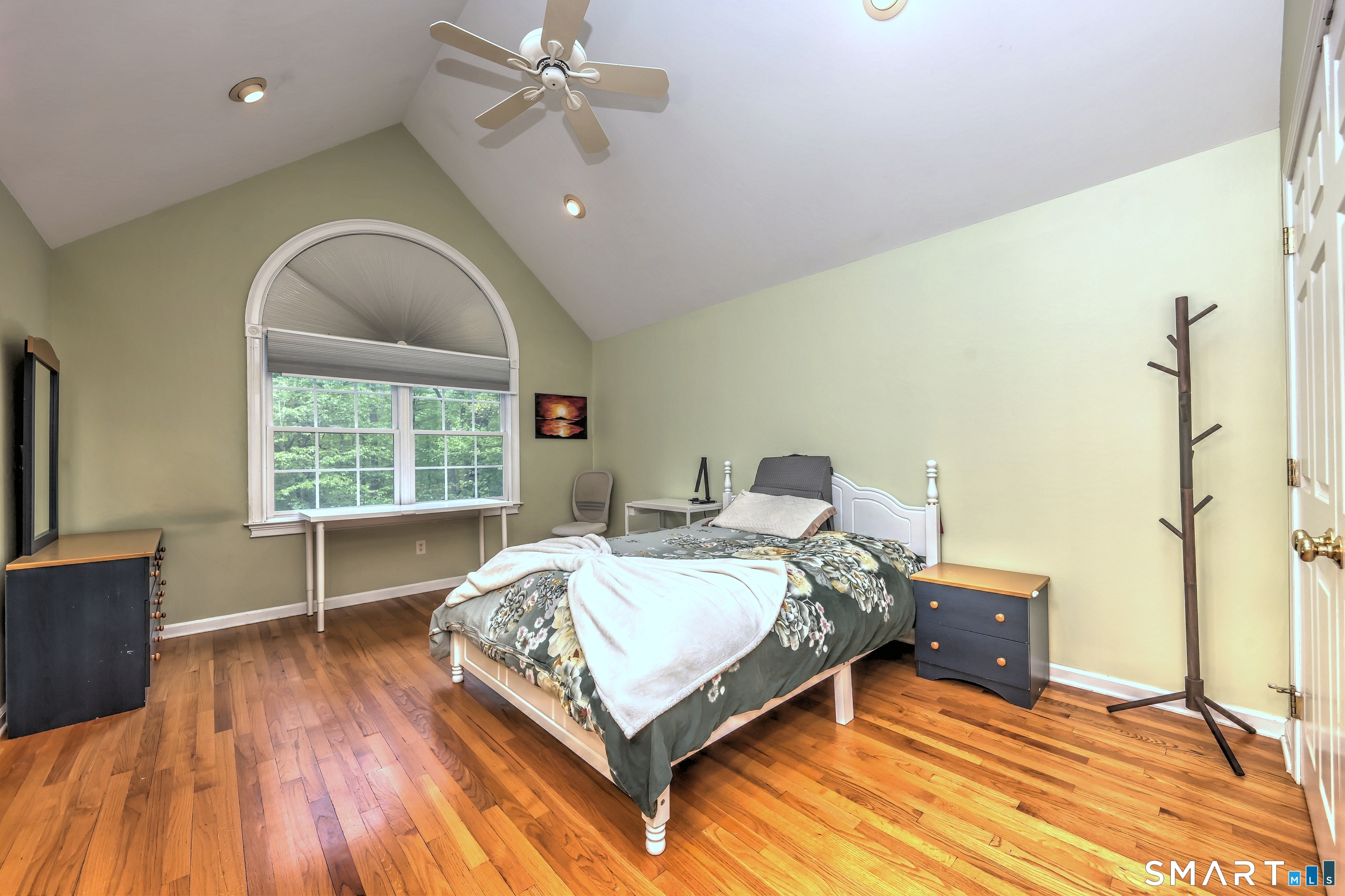 125 Peck Hill Road Woodbridge, CT 06525 - Photo 24 of 40 a bed sitting in a spacious bedroom next to a window