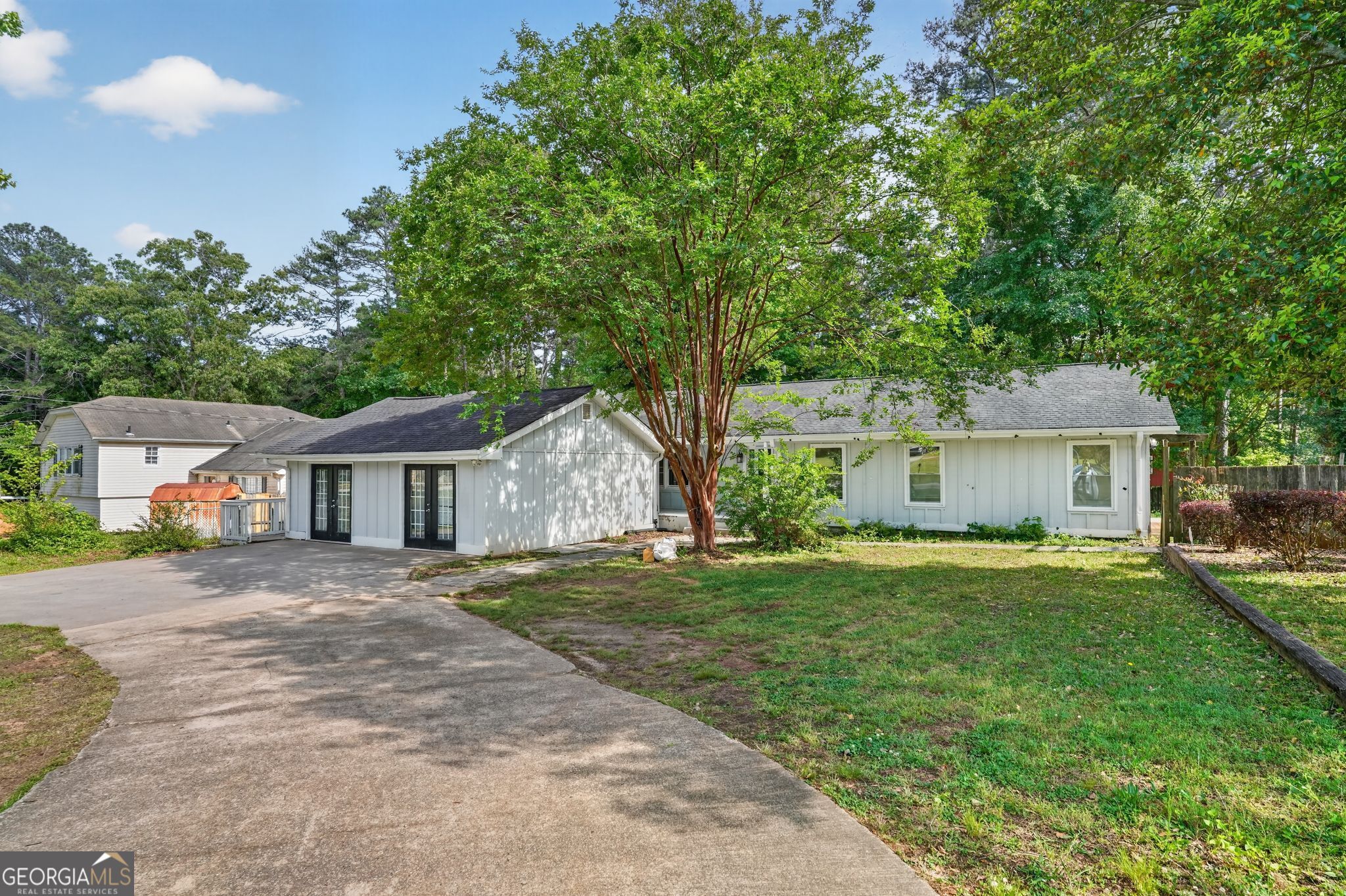 3285 Old Salem Road Southeast Conyers, GA 30013 - Photo 1 of 33 a front view of a house with a garden and trees