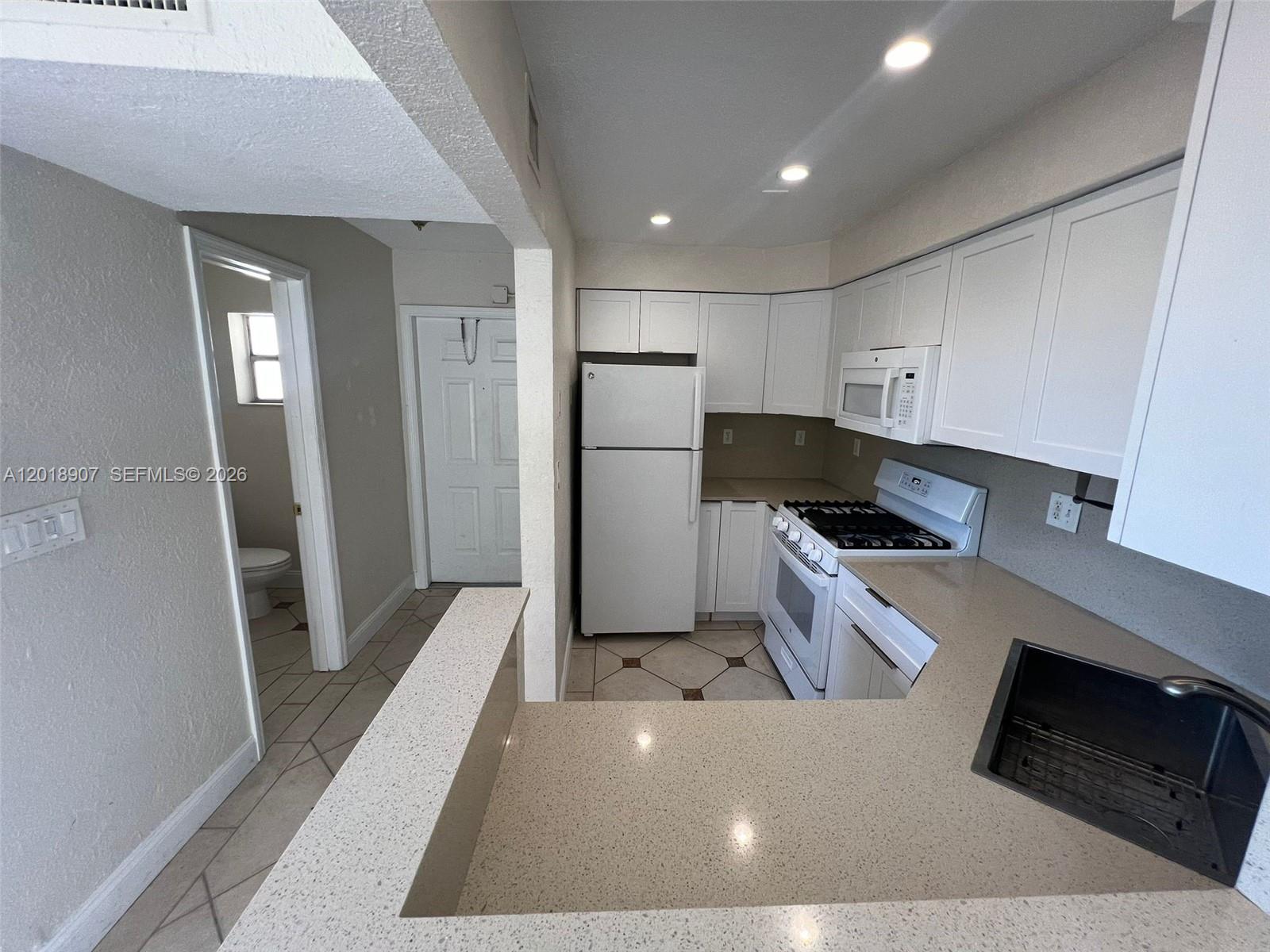8600 Southwest 67th Avenue, Unit 938 Pinecrest, FL 33156 - Photo 2 of 15 a kitchen with refrigerator and cabinets