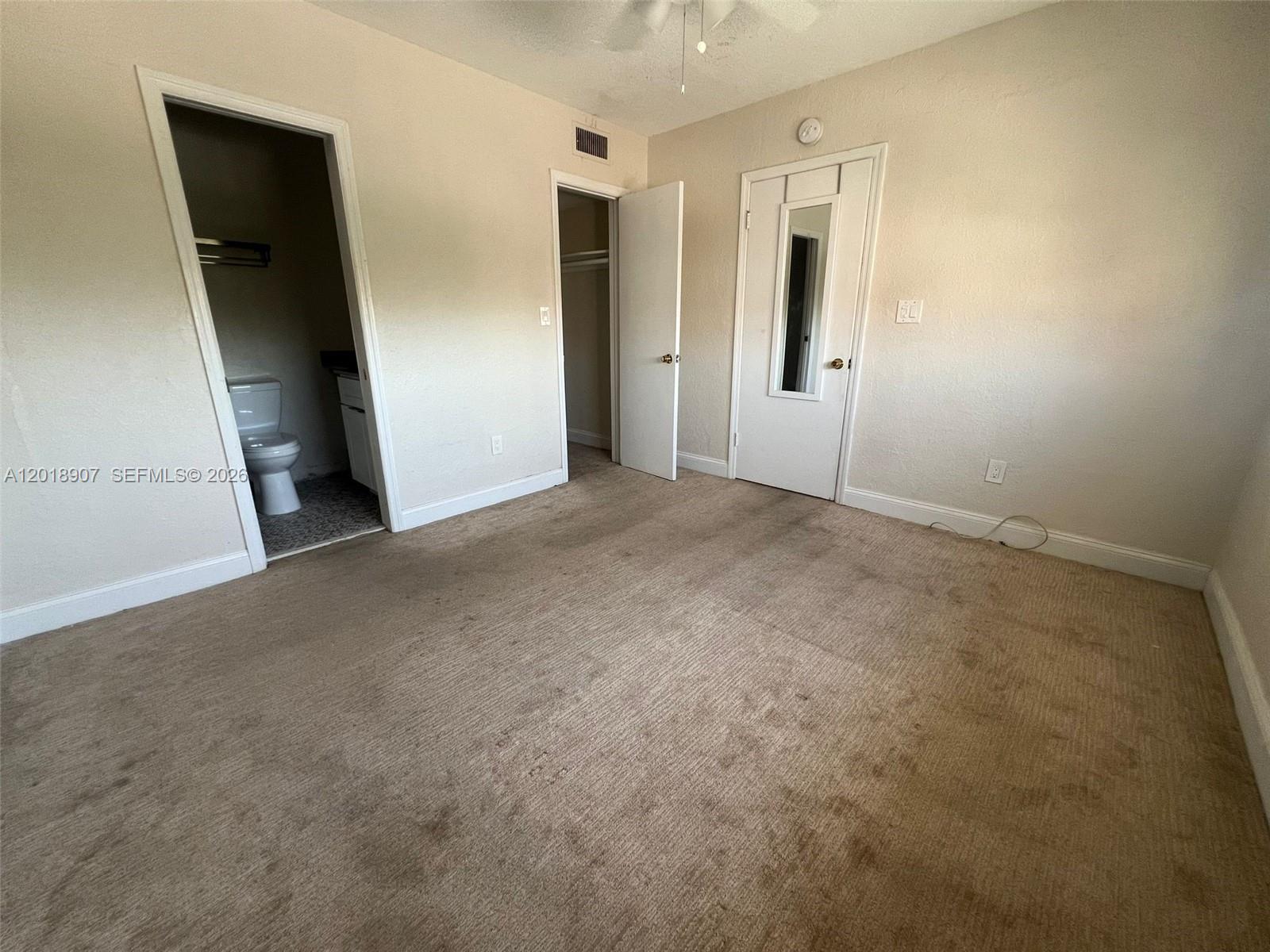 8600 Southwest 67th Avenue, Unit 938 Pinecrest, FL 33156 - Photo 7 of 15 an empty room with closet and mirror