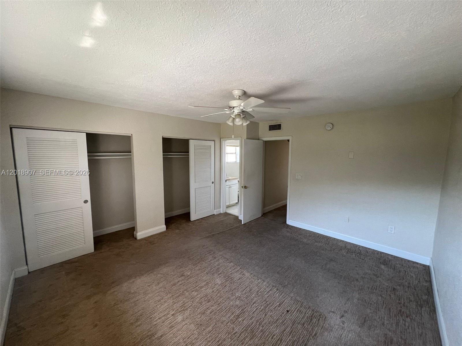 8600 Southwest 67th Avenue, Unit 938 Pinecrest, FL 33156 - Photo 9 of 15 an empty room with closet and windows