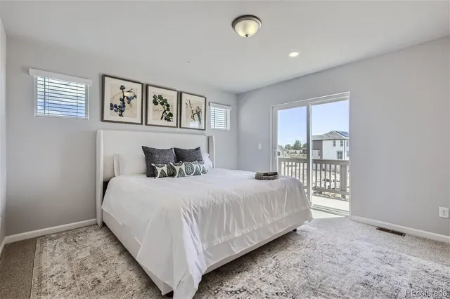 a bedroom with a large bed and a window