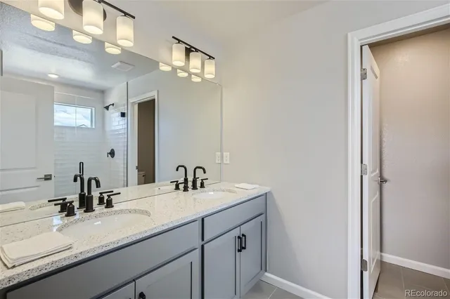 a bathroom with a sink double vanity and a mirror