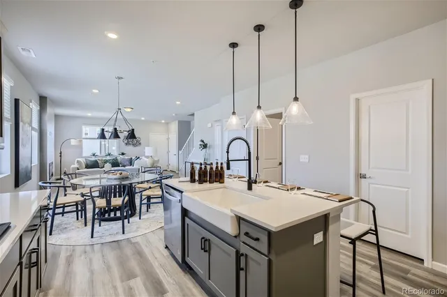 a kitchen with a table chairs sink and cabinets