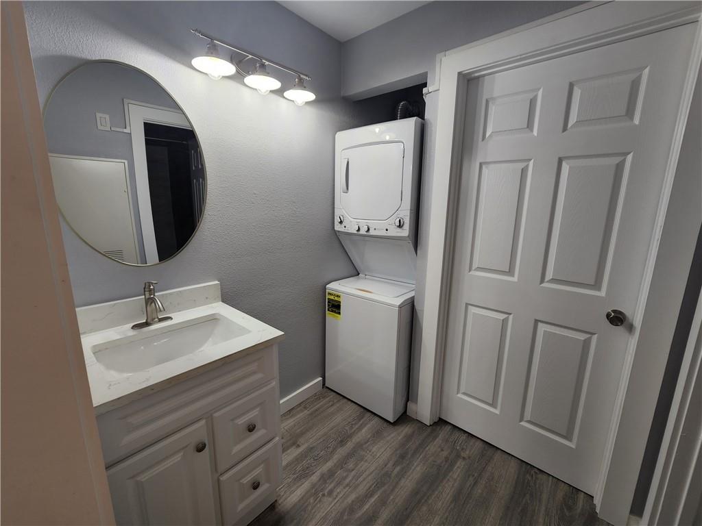 2815 Rio Grande Street, Unit 215 Austin, TX 78705 - Photo 4 of 11 Functional utility space with a compact laundry area and convenient sink vanity.
