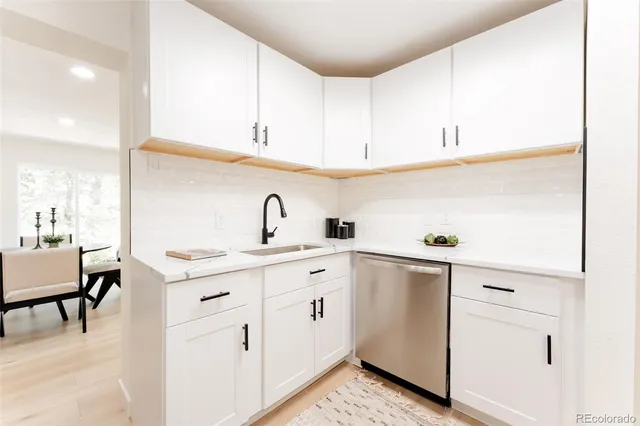 a kitchen with cabinets appliances a sink and a counter