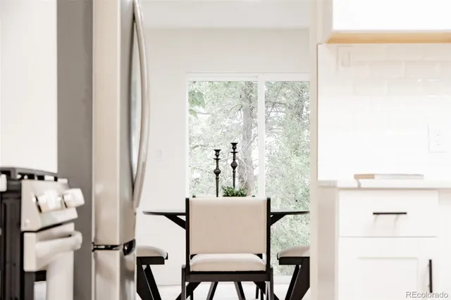 a view of a dining room with furniture and a window