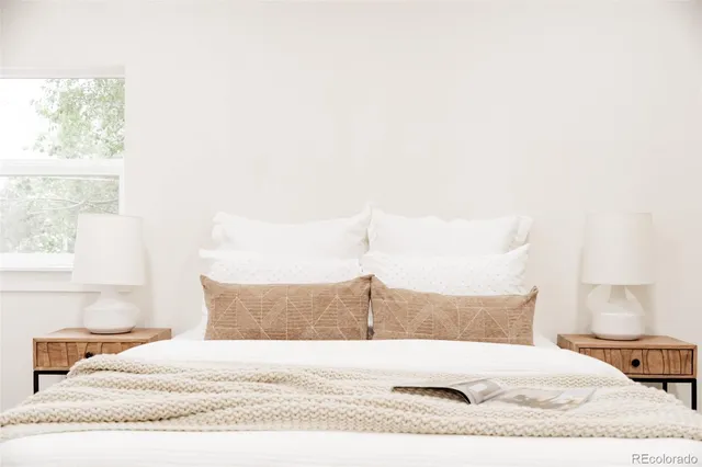 a bedroom with a bed and a night stand