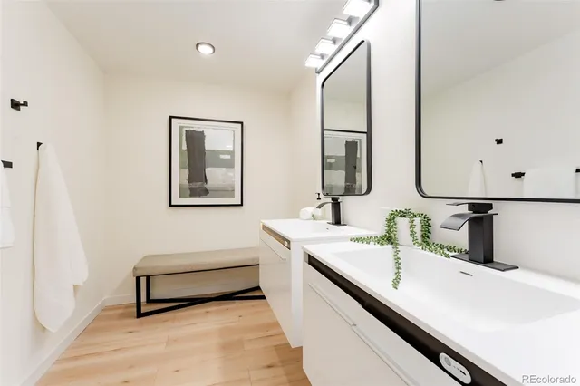 a bathroom with a double vanity sink and a mirror