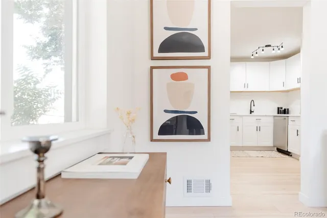 a kitchen with stainless steel appliances kitchen island a white counter space and a window