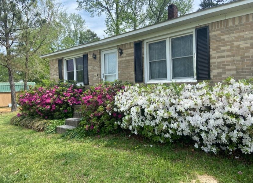 8540-8530 Glendale Road Morris Chapel, TN 38361 - Photo 15 of 21 a flower garden is sitting in front of a house