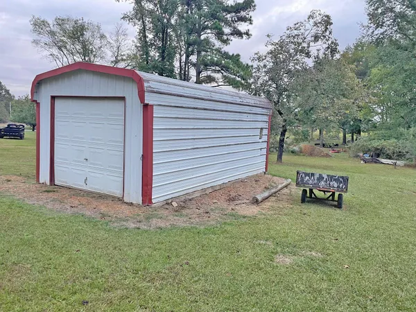 a view of a house with a yard and garage