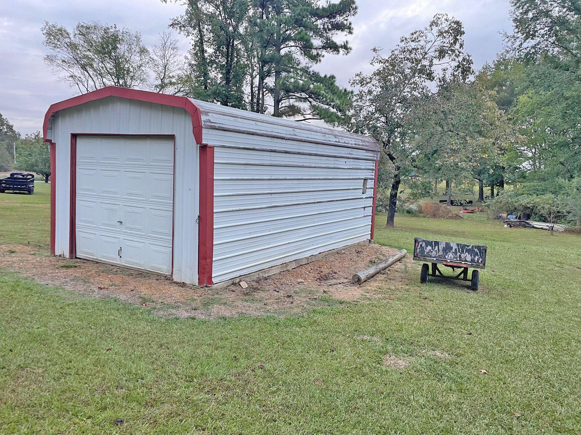 8540-8530 Glendale Road Morris Chapel, TN 38361 - Photo 19 of 21 a view of a house with a yard and garage