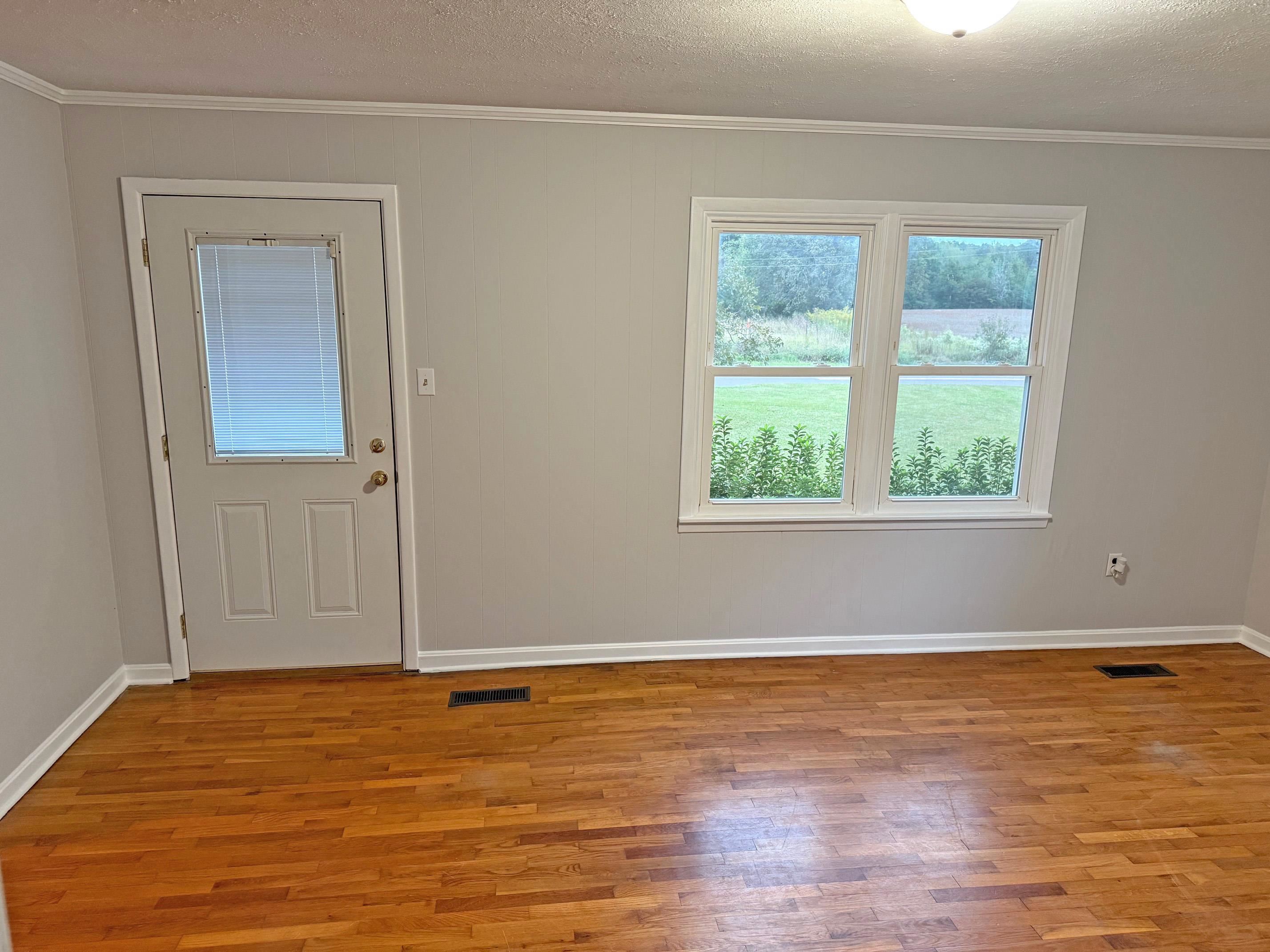 8540-8530 Glendale Road Morris Chapel, TN 38361 - Photo 6 of 21 a view of an empty room with wooden floor and a window