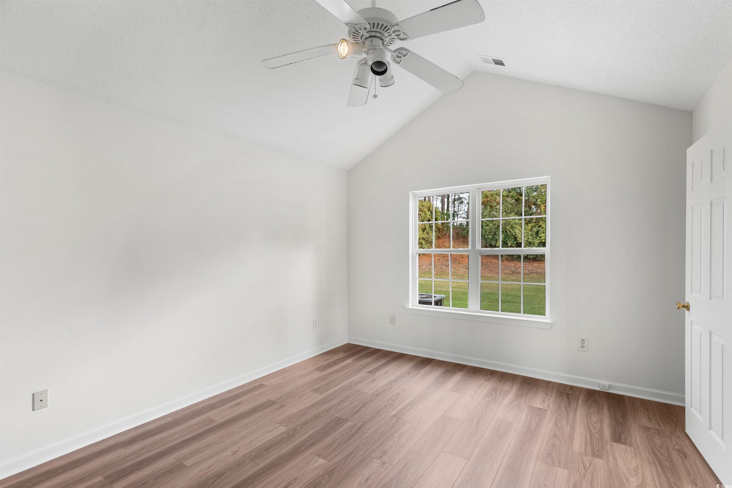 130 Wimbledon Way, Unit 130 Murrells Inlet, SC 29576 - Photo 17 of 38 Empty room with ceiling fan, light hardwood / wood