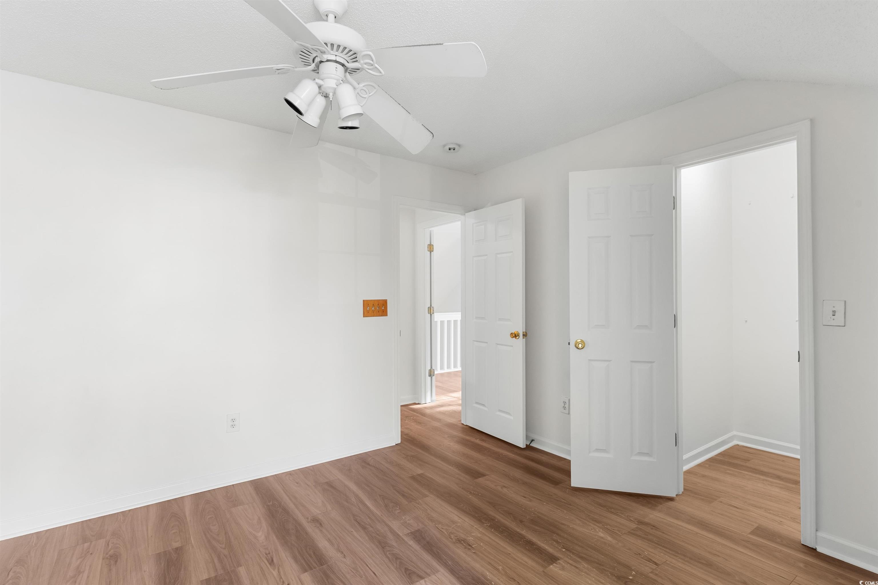 130 Wimbledon Way, Unit 130 Murrells Inlet, SC 29576 - Photo 25 of 38 Unfurnished bedroom with wood-type flooring, ceili