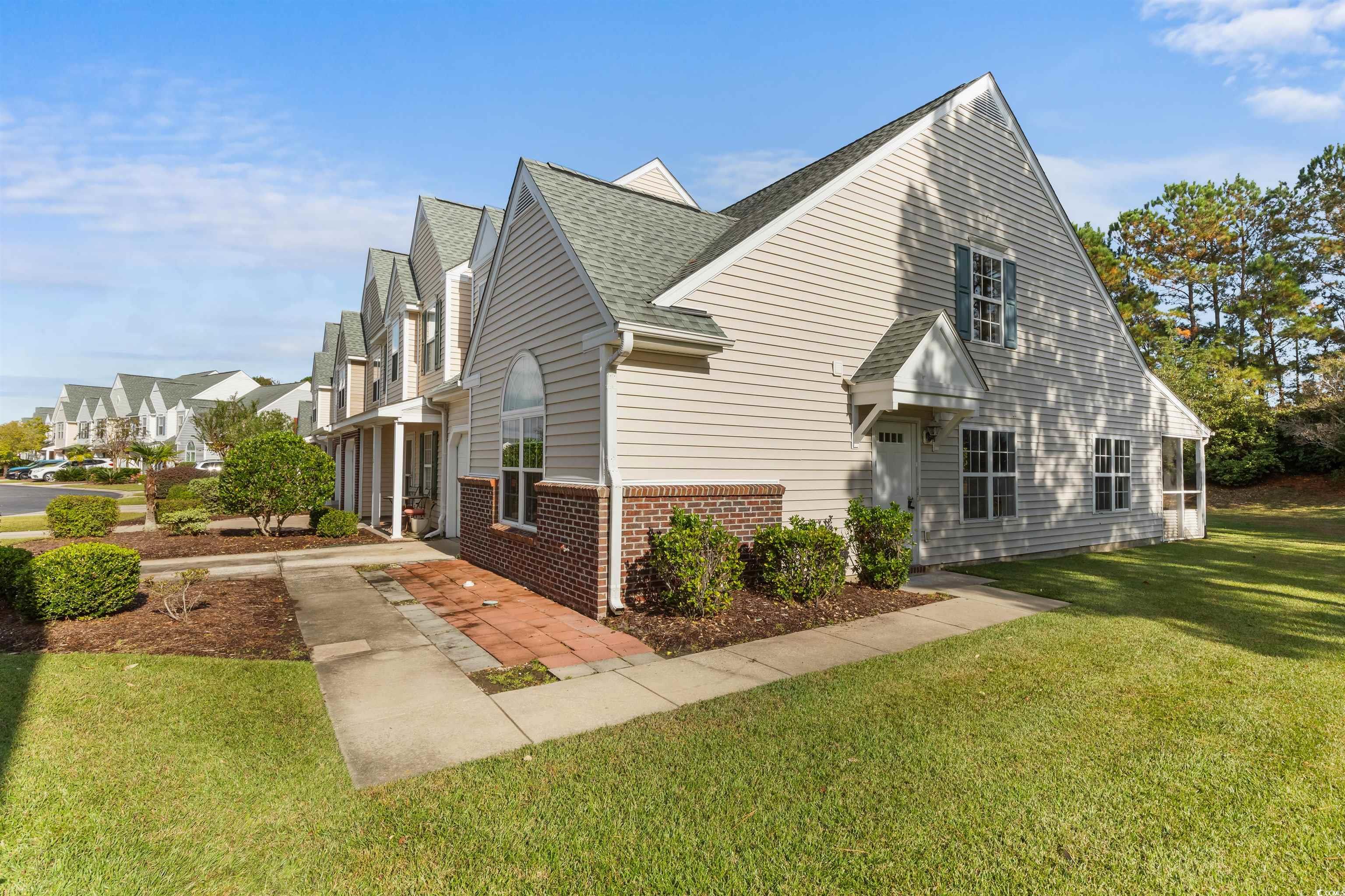 130 Wimbledon Way, Unit 130 Murrells Inlet, SC 29576 - Photo 3 of 38 View of home's exterior featuring a lawn