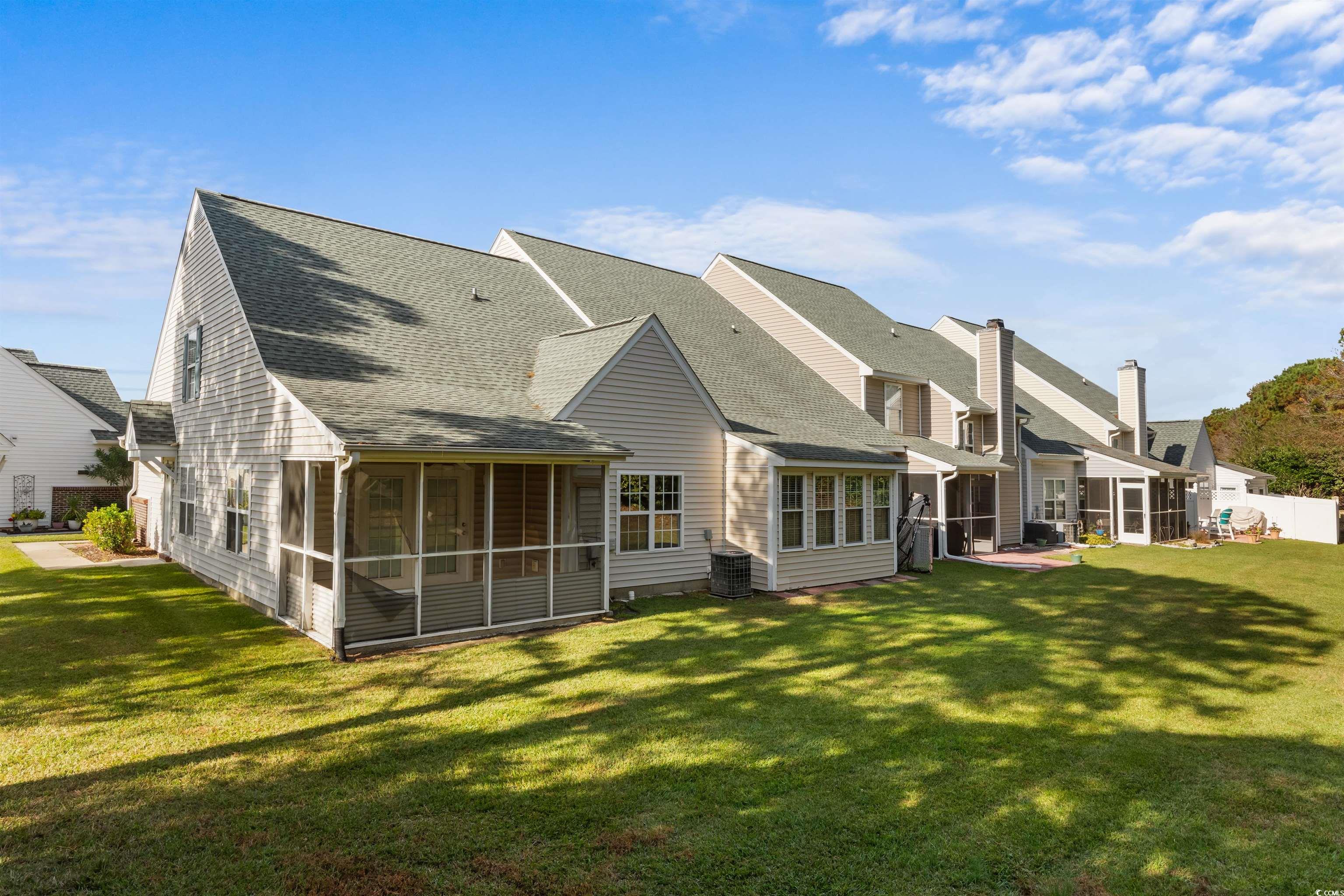 130 Wimbledon Way, Unit 130 Murrells Inlet, SC 29576 - Photo 31 of 38 Rear view of property with central AC unit, a sunr