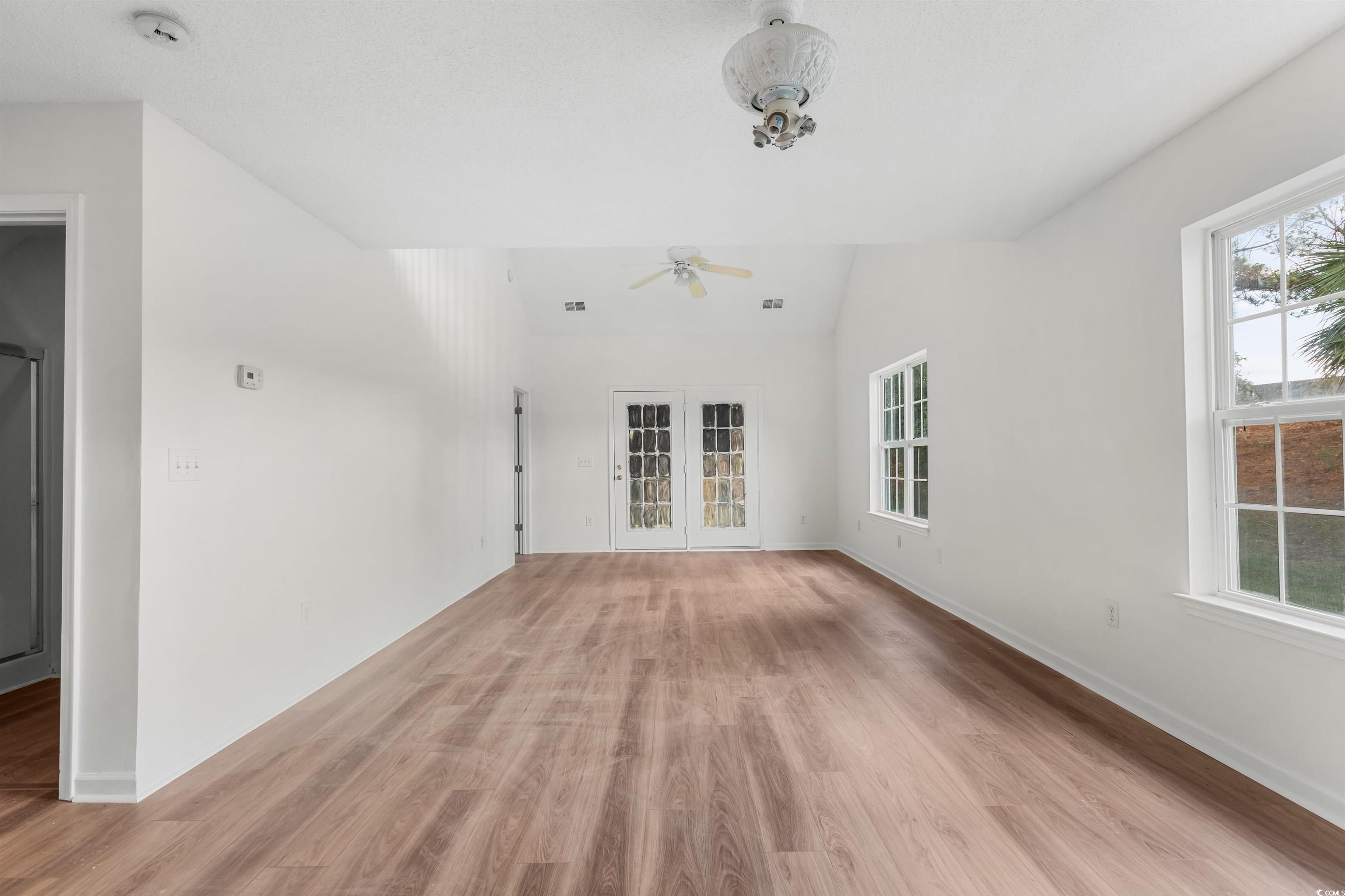 130 Wimbledon Way, Unit 130 Murrells Inlet, SC 29576 - Photo 5 of 38 Unfurnished living room featuring french doors, li