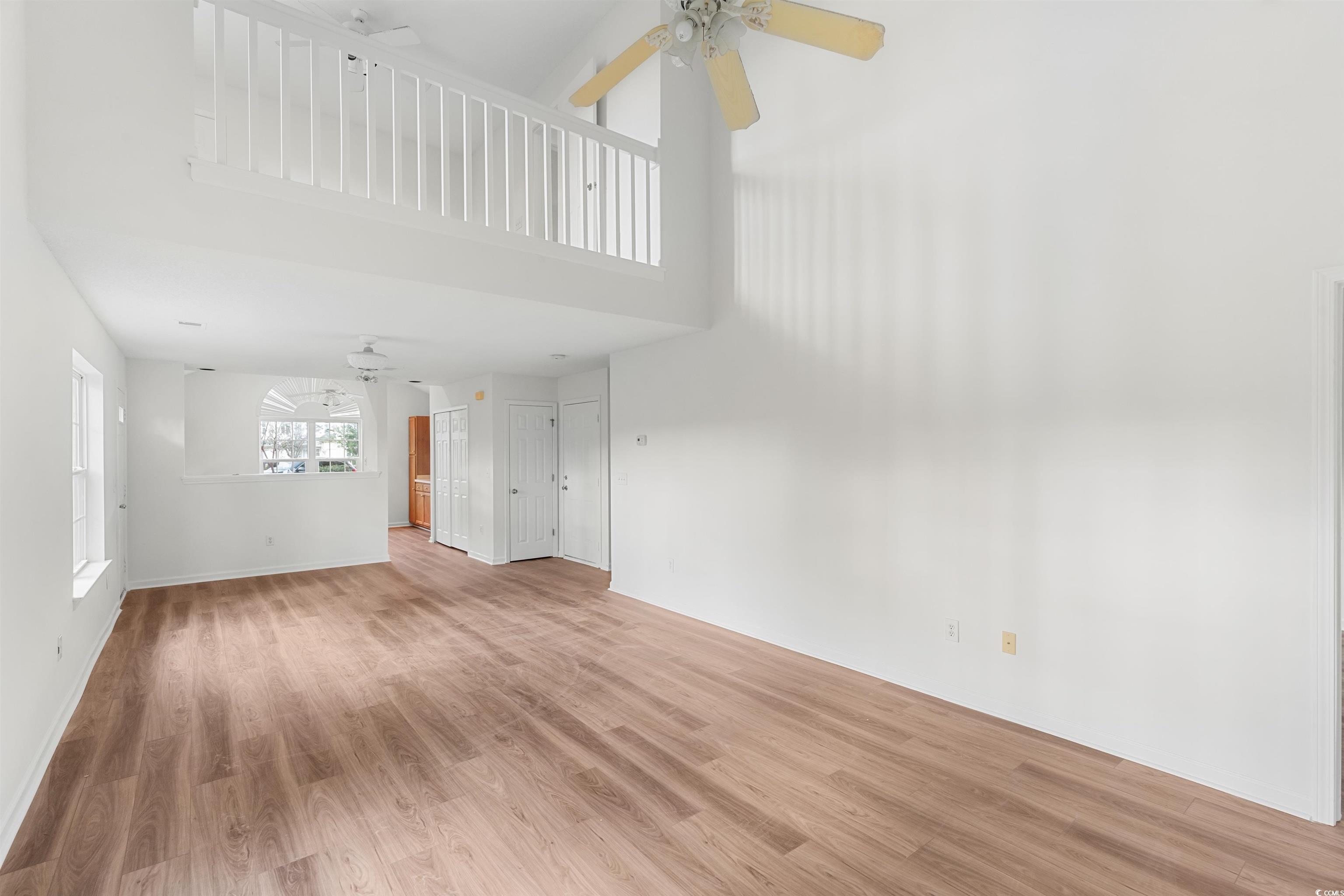 130 Wimbledon Way, Unit 130 Murrells Inlet, SC 29576 - Photo 7 of 38 Unfurnished living room with wood-type flooring, c