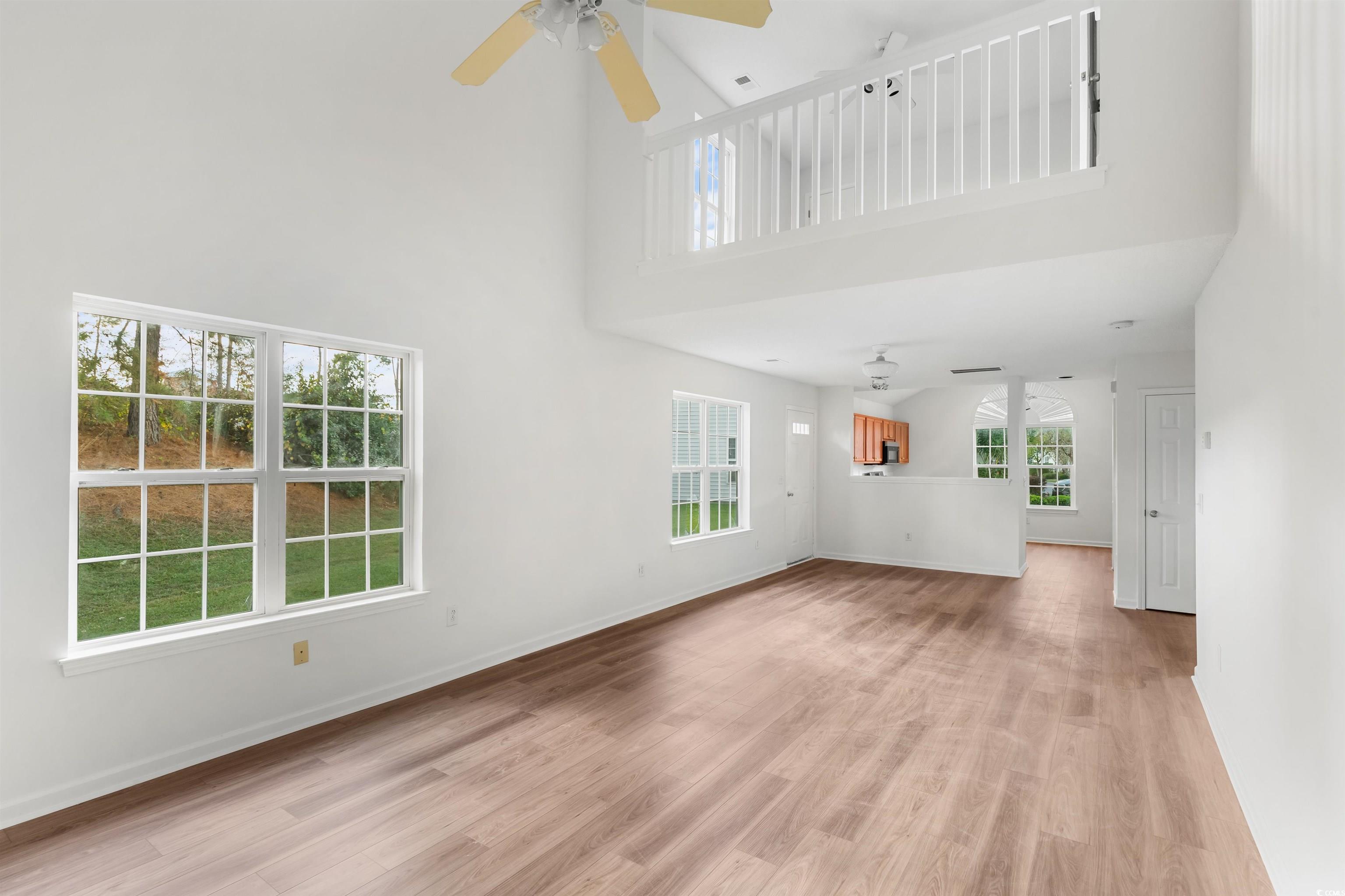 130 Wimbledon Way, Unit 130 Murrells Inlet, SC 29576 - Photo 9 of 38 Unfurnished living room with light hardwood / wood