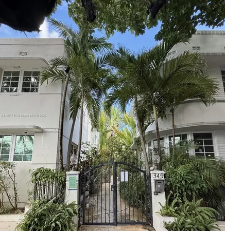 a front view of a house with a tree