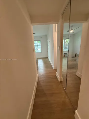 a view of hallway with wooden floor