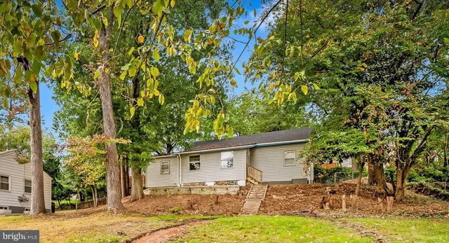 a backyard of a house with yard and outdoor seating