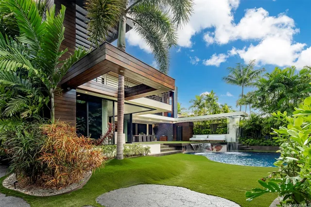 a view of a house with backyard porch and sitting area